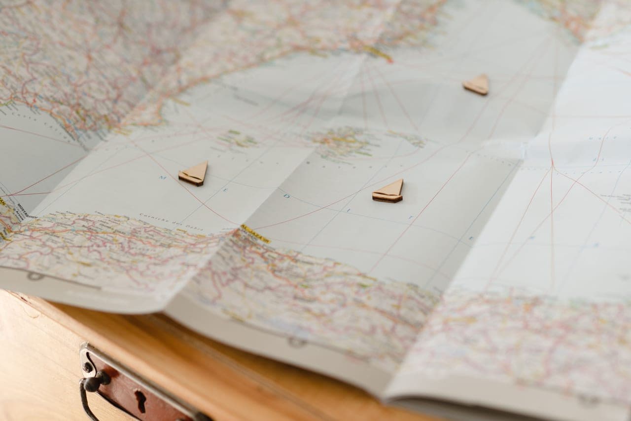 A world map board with markers placed across it