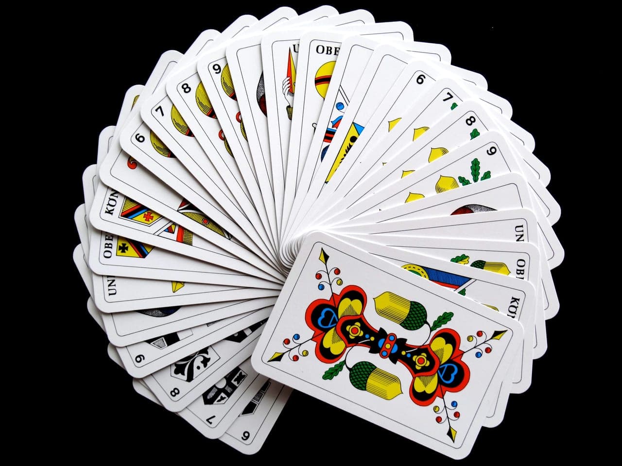 Colorful illustrated playing cards fanned out on a table