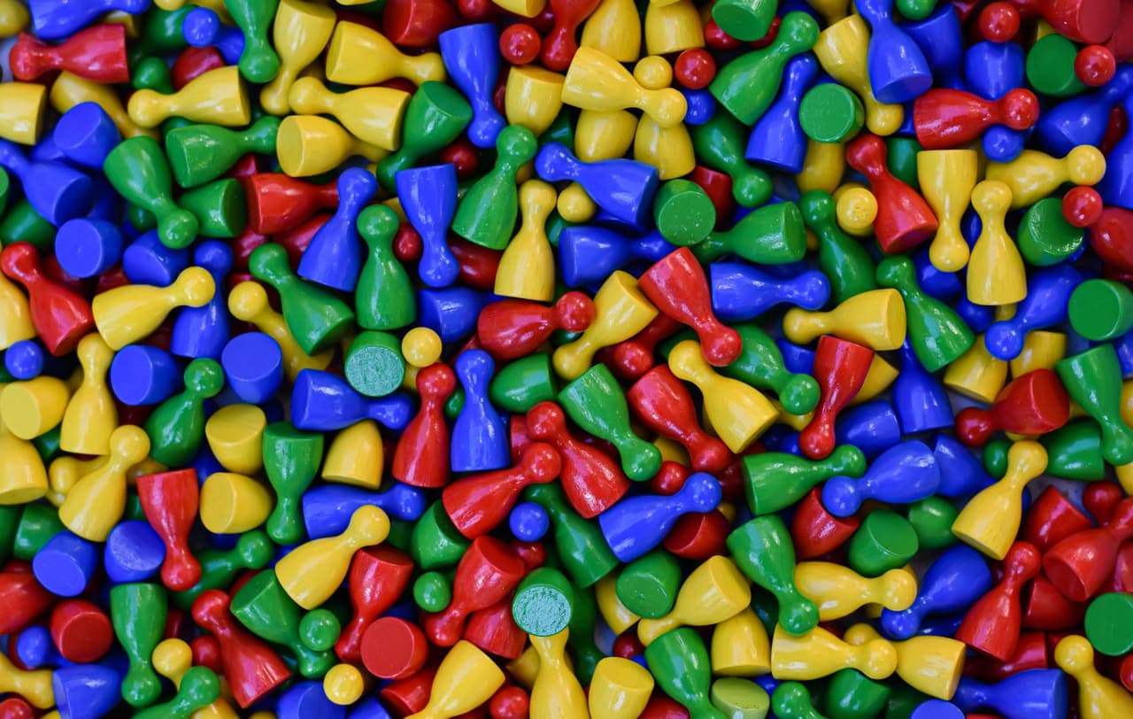 A spread of colorful plastic game pieces seen from above