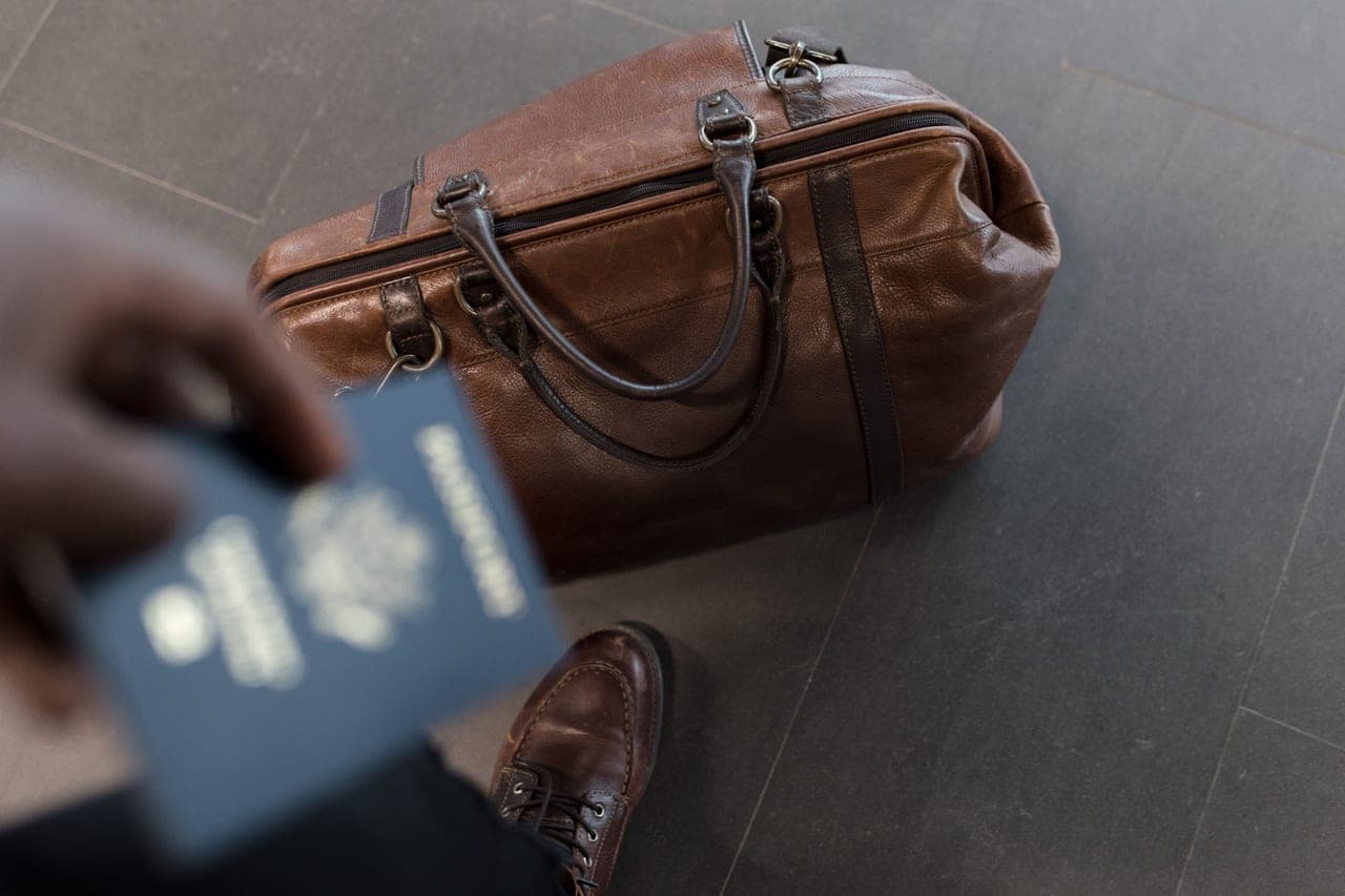 A small card game and a passport packed into an open bag