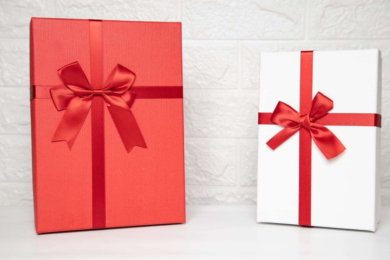 A large illustrated board game box presented as a gift