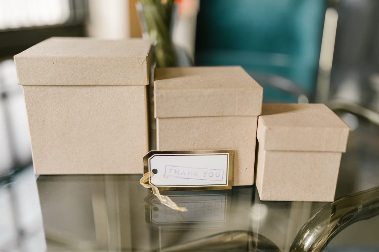 Several small card game boxes stacked on a table