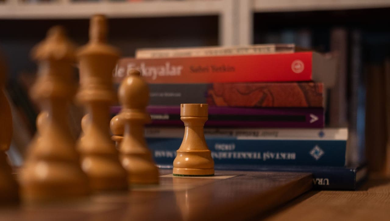 Two board game boxes stacked beside each other on a shelf