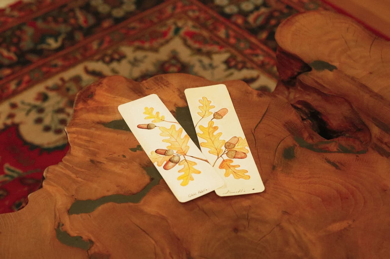 Two illustrated nature cards laid on a rustic wooden table